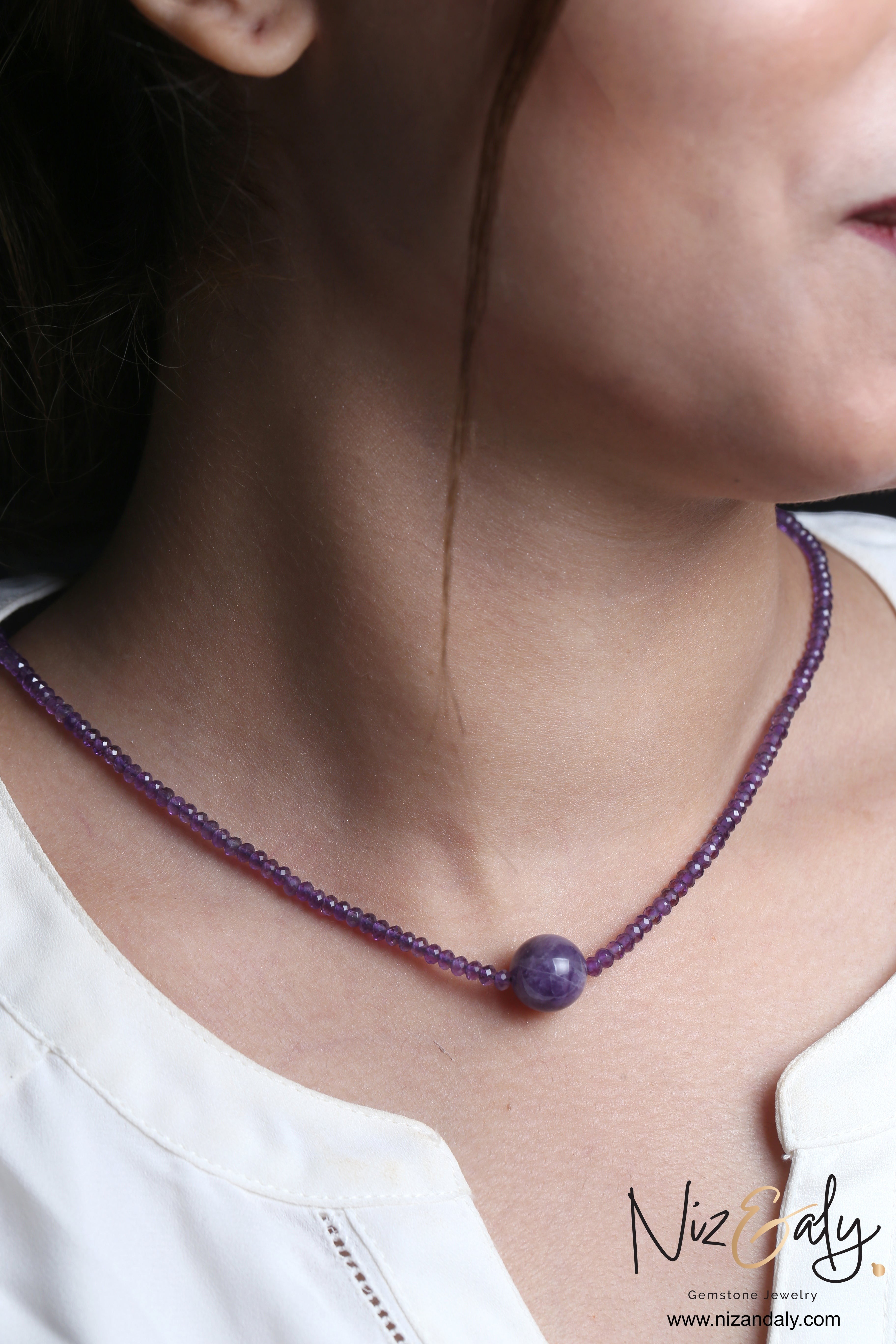 Niz & Aly Celestial Dew amethyst necklace featuring small faceted beads and a central smooth 12mm amethyst sphere