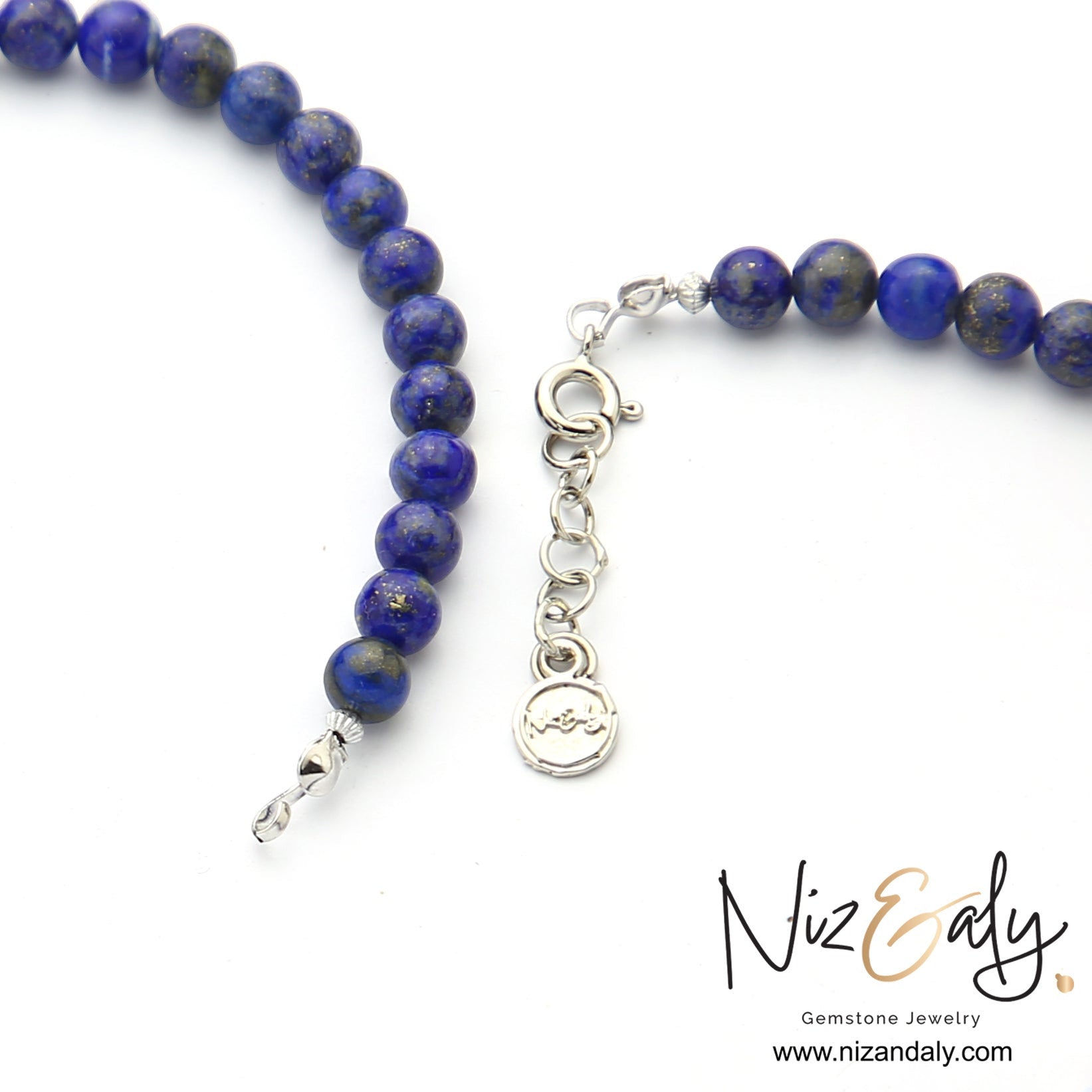 Niz & Aly handcrafted lapis lazuli beaded necklace with deep blue round gemstones and silver clasp detail.