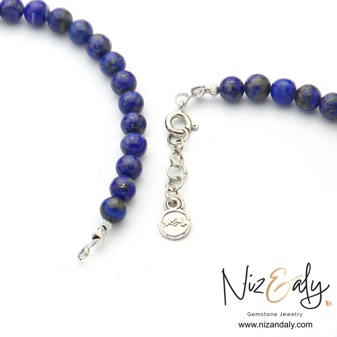 Niz & Aly handcrafted lapis lazuli beaded necklace with deep blue round gemstones and silver clasp detail.