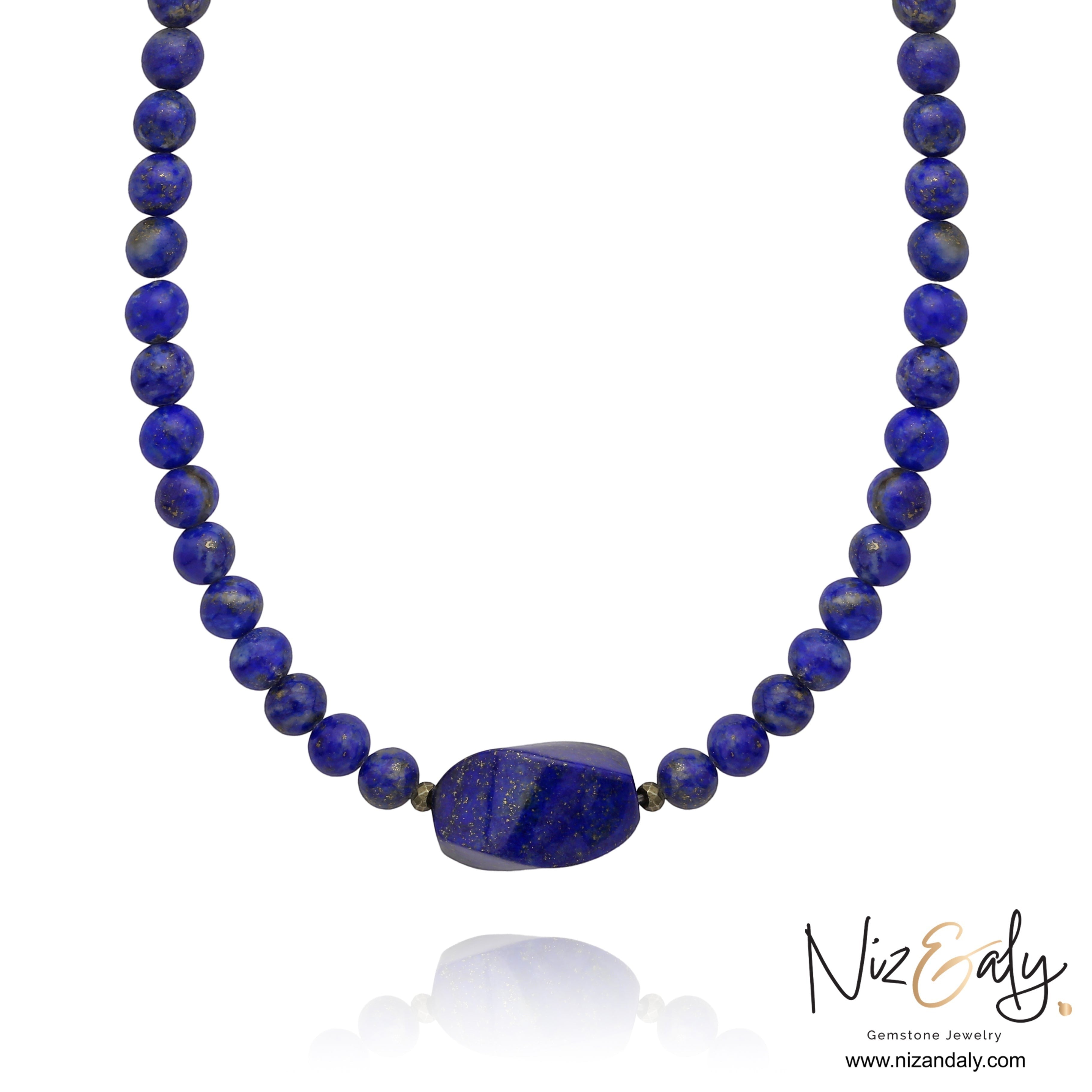 Niz & Aly Lapis Lazuli beaded necklace featuring a central deep blue gemstone with natural golden flecks.
