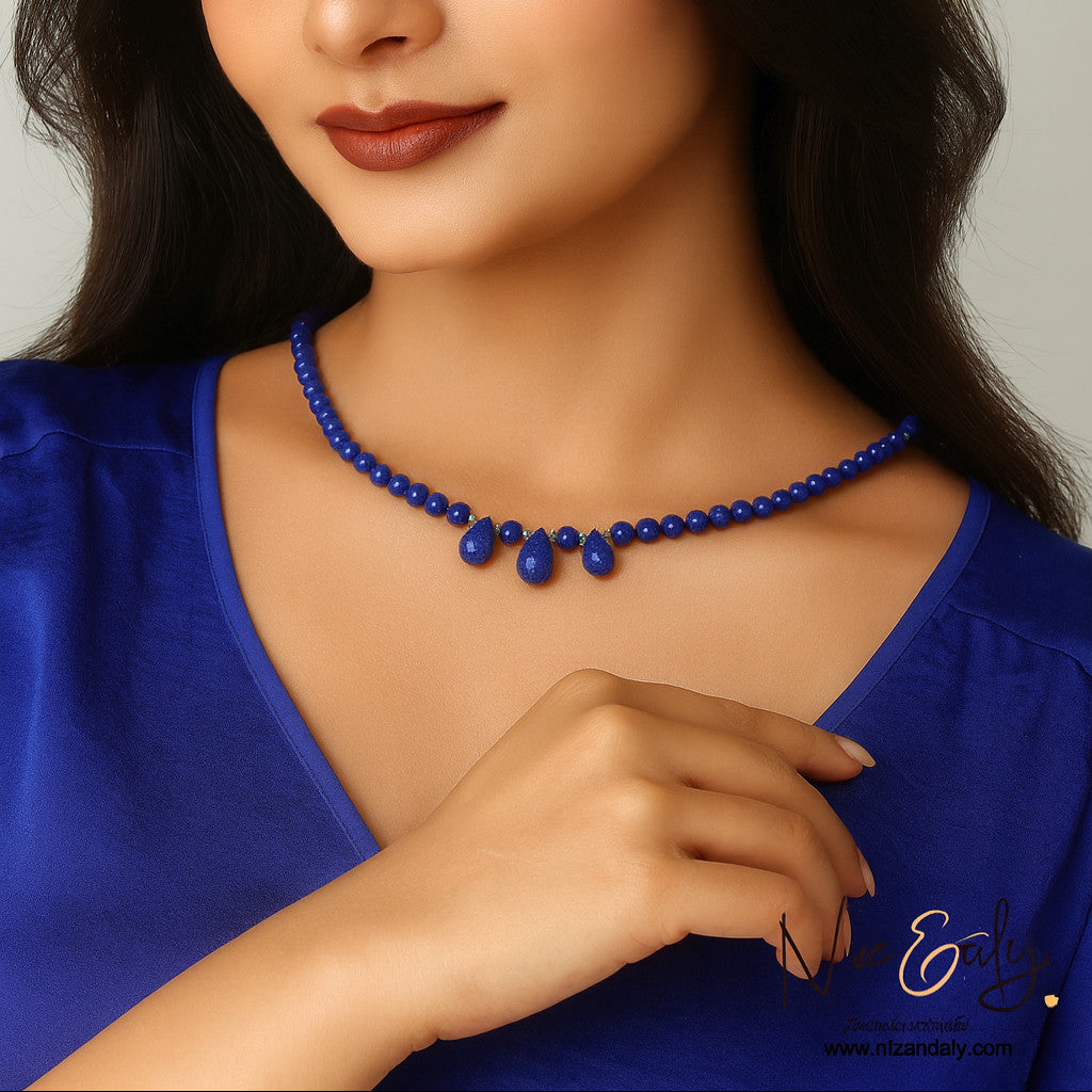 Niz & Aly minimalist lapis lazuli necklace with three teardrop pendants and round beads on a woman wearing blue