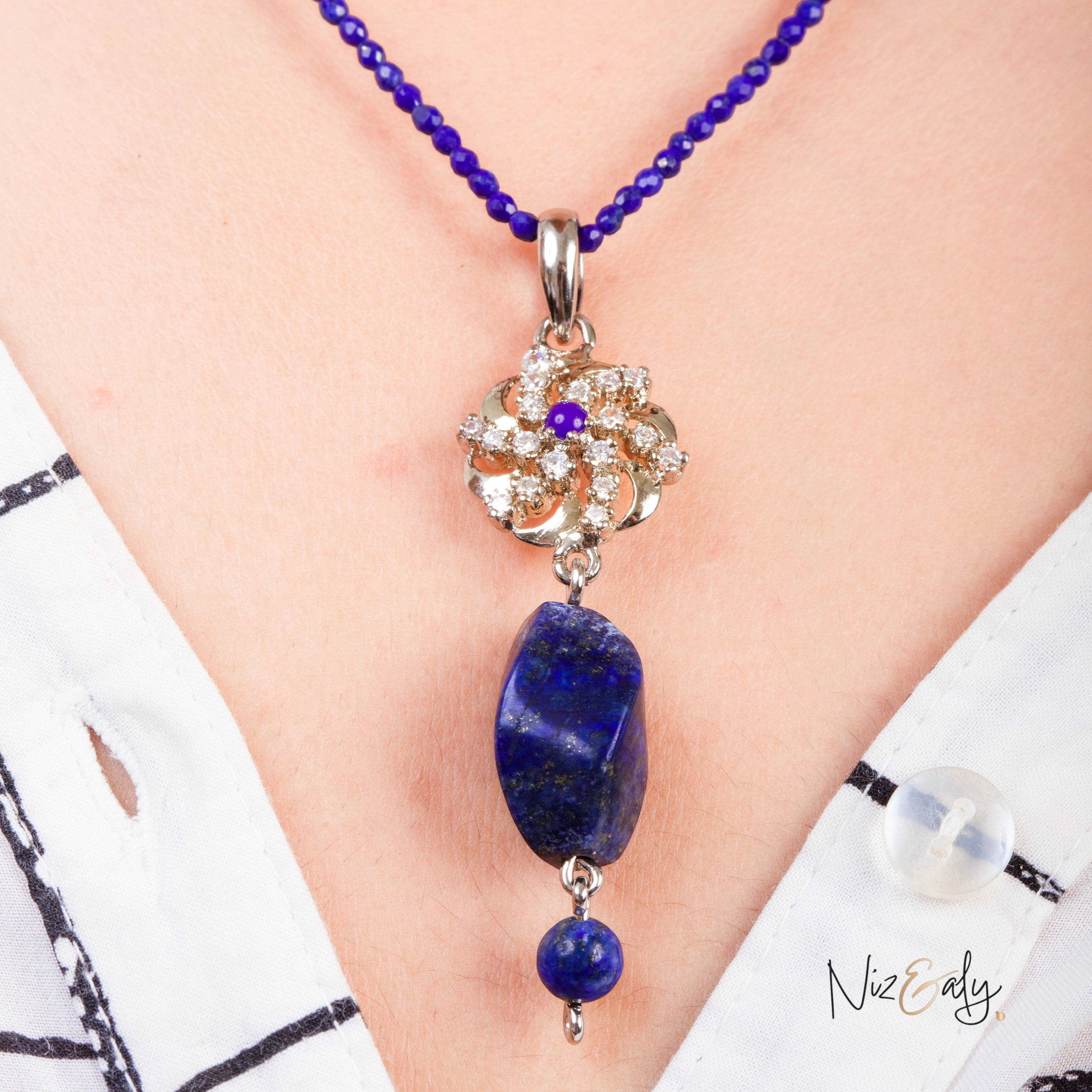 Niz & Aly lapis locket on a dainty faceted blue lapis bead string worn on a white collared shirt