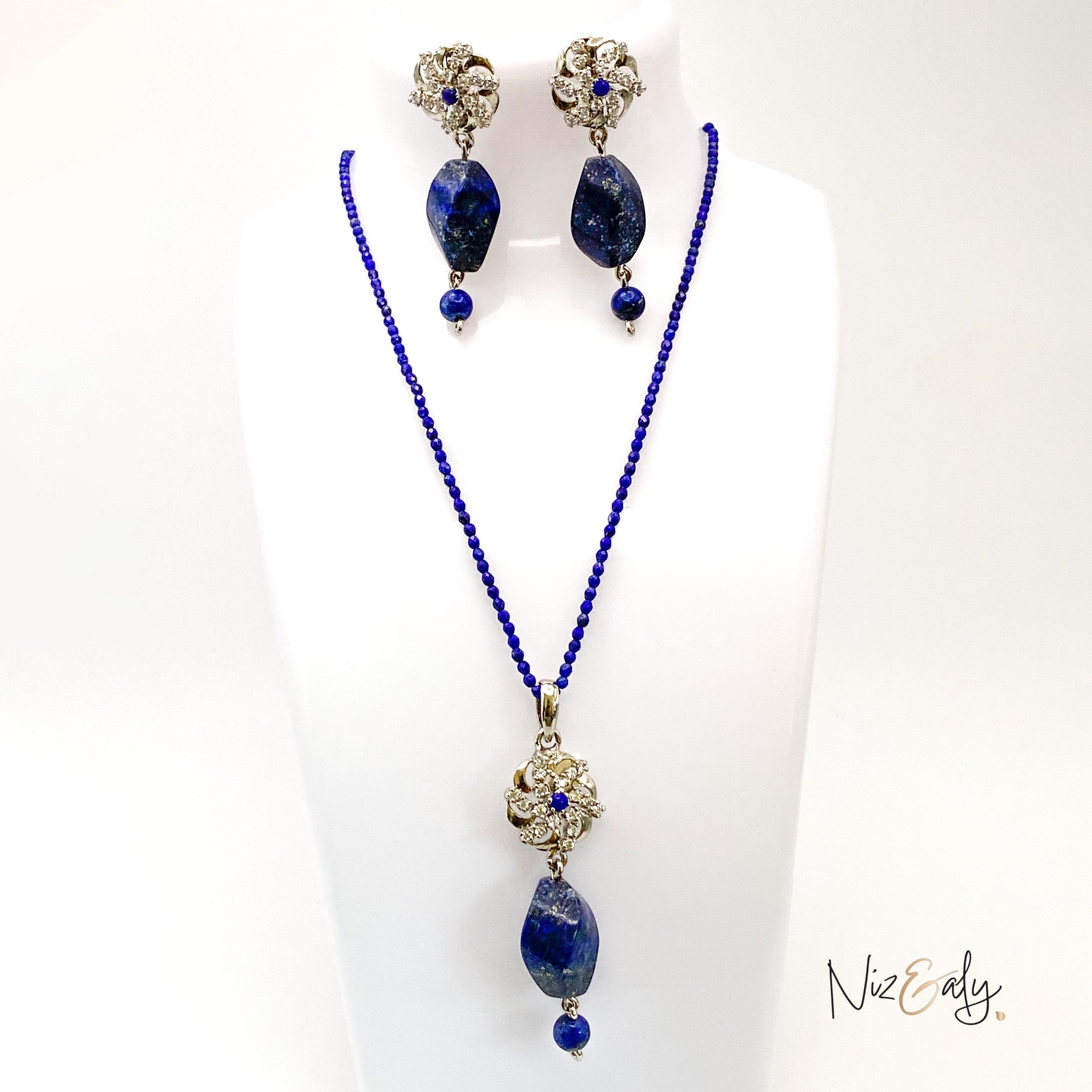 Niz & Aly lapis locket necklace and matching earrings set with deep blue faceted lapis beads on a white display bust