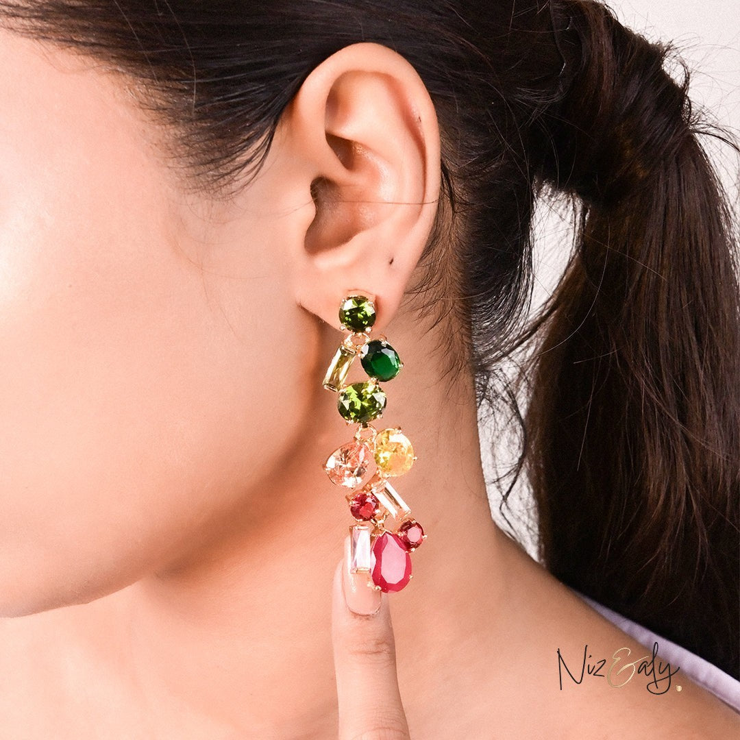 Niz & Aly crystal drop earrings featuring multi-colored faceted stones worn on a model's ear.
