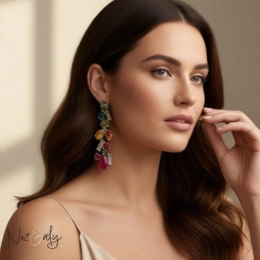 Niz & Aly crystal drop earrings featuring multi-colored faceted teardrop stones worn by a woman with long brown hair.