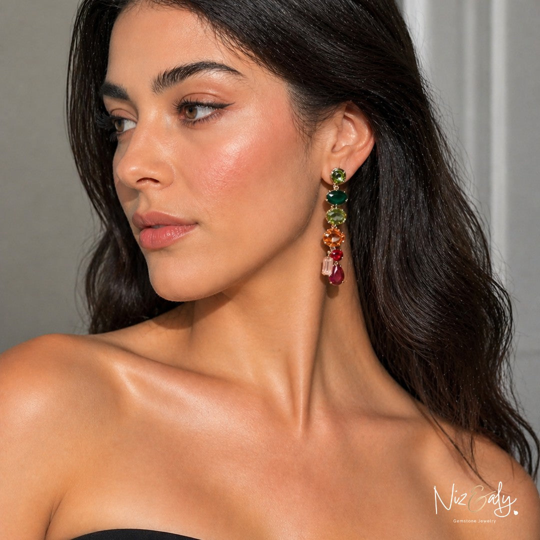 Niz & Aly crystal drop earrings featuring a multi-colored gemstone design worn by a woman with dark wavy hair