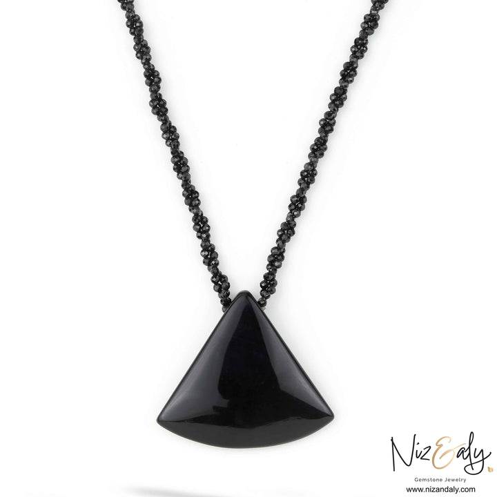 Niz & Aly Agate Eclipse necklace featuring a smooth triangular black agate pendant on a beaded black onyx chain.