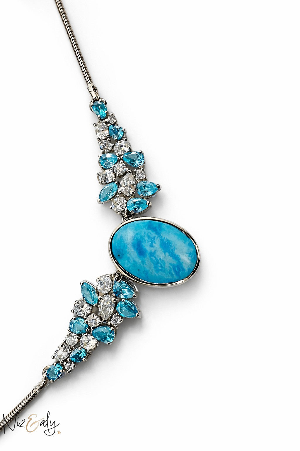 Niz & Aly Whisper of Nishapur statement necklace featuring a large oval natural turquoise stone with blue and clear crystals.